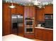 Modern kitchen featuring stainless steel appliances, custom wood cabinets, and tiled backsplash at 12740 Amber Ave, Clermont, FL 34711