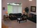Comfortable living room with plush sofas, ambient lighting, and a serene window view at 12740 Amber Ave, Clermont, FL 34711