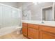 Bathroom features a shower/tub combo, tile floors, and a vanity with storage at 13852 Eylewood Dr, Winter Garden, FL 34787