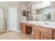 Primary bathroom features dual sinks, a walk-in shower, and a private toilet area at 13852 Eylewood Dr, Winter Garden, FL 34787