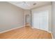 Bedroom with ceiling fan, wood-look floors, and closet featuring double doors at 13852 Eylewood Dr, Winter Garden, FL 34787
