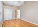 Bedroom with ceiling fan, wood-look floors, and closet with double doors at 13852 Eylewood Dr, Winter Garden, FL 34787