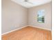 Bedroom with ceiling fan, wood-look floors, and a window with a view at 13852 Eylewood Dr, Winter Garden, FL 34787
