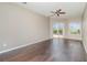 Bright bedroom offers hardwood floors, a ceiling fan, and a sliding glass door to the pool at 13852 Eylewood Dr, Winter Garden, FL 34787
