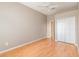 Inviting bedroom with wood floors, ceiling fan, and a double-door closet for ample storage at 13852 Eylewood Dr, Winter Garden, FL 34787