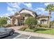 Elegant clubhouse entrance with stone accents, manicured landscaping, and convenient parking at 13852 Eylewood Dr, Winter Garden, FL 34787
