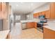 Bright kitchen features stainless appliances, tile floors, and an open layout to the living area at 13852 Eylewood Dr, Winter Garden, FL 34787