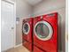 Convenient laundry room features a side-by-side washer and dryer, tiled floors, and shelving at 13852 Eylewood Dr, Winter Garden, FL 34787