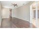 Open living room with hardwood floors, ceiling fan, and sliding glass door to a balcony at 13852 Eylewood Dr, Winter Garden, FL 34787