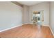 Bright living room with wood floors, neutral walls, and sliding glass doors leading to an outdoor pool at 13852 Eylewood Dr, Winter Garden, FL 34787