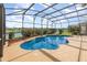 Screened in pool with a unique pool and spa design featuring a water view at 13852 Eylewood Dr, Winter Garden, FL 34787