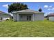 The back exterior of a home with a large lawn at 14 Morton Rd, Winter Haven, FL 33881