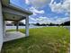 Spacious backyard with white fence and covered patio area at 14 Morton Rd, Winter Haven, FL 33881