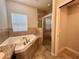 Bathroom with walk-in shower and soaking tub next to a bright window at 14 Morton Rd, Winter Haven, FL 33881