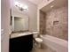 Bathroom featuring a granite countertop, tile flooring, and a bathtub with tiled walls at 14 Morton Rd, Winter Haven, FL 33881