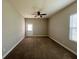 Spacious bedroom featuring a ceiling fan, carpet flooring, and a door to the outside at 14 Morton Rd, Winter Haven, FL 33881