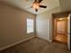 Bedroom with a ceiling fan, closet, and a view into the hallway and another bedroom at 14 Morton Rd, Winter Haven, FL 33881