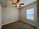 A cozy bedroom with a ceiling fan, a window with blinds, and plush carpeting at 14 Morton Rd, Winter Haven, FL 33881