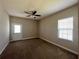 Bedroom with neutral walls, carpet flooring, a ceiling fan, and a door to the outside at 14 Morton Rd, Winter Haven, FL 33881