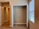 Bedroom closet with bi-fold doors and shelving, offering ample storage space inside a well lit area at 14 Morton Rd, Winter Haven, FL 33881