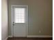 White door with blinds between the glass and neutral carpet at 14 Morton Rd, Winter Haven, FL 33881