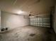 Well lit two-car garage with an automatic garage door and concrete floor, perfect for storage and parking at 14 Morton Rd, Winter Haven, FL 33881