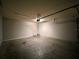 Clean two-car garage with an automatic garage door and concrete floor perfect for parking and storage at 14 Morton Rd, Winter Haven, FL 33881