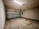 Spacious two-car garage with automatic door and concrete floor offering secure parking and storage at 14 Morton Rd, Winter Haven, FL 33881