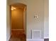 Hallway view with neutral walls, tiled flooring, and an archway, leading to other parts of the home at 14 Morton Rd, Winter Haven, FL 33881