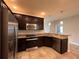 Stylish kitchen with stainless steel appliances, granite countertops, dark cabinetry, and tile floors at 14 Morton Rd, Winter Haven, FL 33881