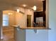 Open-concept kitchen with granite countertop bar overlooking dining area with stainless steel appliances and tile flooring at 14 Morton Rd, Winter Haven, FL 33881