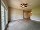 Spacious living room featuring neutral walls, plush carpet, a ceiling fan, and access to the kitchen area at 14 Morton Rd, Winter Haven, FL 33881