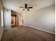 A spacious primary bedroom featuring neutral walls, carpet flooring, and doorways to other rooms at 14 Morton Rd, Winter Haven, FL 33881