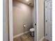 Small half-bathroom with white toilet and pedestal sink at 14 Morton Rd, Winter Haven, FL 33881