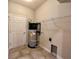 Functional utility room boasts a modern water heater and tiled flooring with ample wall storage at 14 Morton Rd, Winter Haven, FL 33881