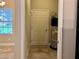 Functional utility room features a modern water heater, storage shelves, and tiled flooring for easy maintenance at 14 Morton Rd, Winter Haven, FL 33881