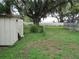 Expansive backyard with mature trees and a storage shed, offering ample space at 1440 Hackl Blvd, Bartow, FL 33830