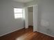 This bedroom features hardwood floors, a window for natural light and a closet with bi-fold doors at 1440 Hackl Blvd, Bartow, FL 33830