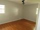 Bedroom with hardwood floors, a ceiling fan, and natural light from two windows at 1440 Hackl Blvd, Bartow, FL 33830