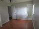 Spacious bedroom with hardwood floors and ample natural light, with a view into bathroom at 1440 Hackl Blvd, Bartow, FL 33830
