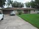 Charming single-story home with a well-maintained lawn, driveway, and attached garage at 1440 Hackl Blvd, Bartow, FL 33830