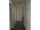 Hallway with dark wood floors, white doors, and neutral-colored walls at 1440 Hackl Blvd, Bartow, FL 33830