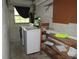 Well-lit laundry room with washer, dryer, and shelving for storage at 1440 Hackl Blvd, Bartow, FL 33830