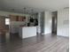 Spacious living room open to kitchen, featuring modern floors and a central island at 1440 Hackl Blvd, Bartow, FL 33830