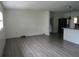 Open concept living room and kitchen with modern vinyl floors and natural light at 1440 Hackl Blvd, Bartow, FL 33830