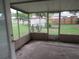 Enclosed patio offering serene views of the backyard and landscaping at 1440 Hackl Blvd, Bartow, FL 33830