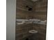 Close-up of a tiled shower with modern fixtures and decorative accents at 1440 Hackl Blvd, Bartow, FL 33830