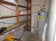 This utility room has a water heater, shelving, and water pipes at 1440 Hackl Blvd, Bartow, FL 33830