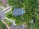 Aerial view of a private backyard with a screened pool, surrounded by mature trees at 1589 Royal Forest Ct, Lakeland, FL 33811