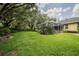 Expansive backyard with a screened-in lanai and well-maintained lawn, ideal for outdoor activities at 1589 Royal Forest Ct, Lakeland, FL 33811